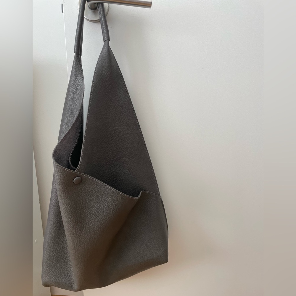 Slouchy tote in pebbled graphite leather with suede lining. Excellent condition!